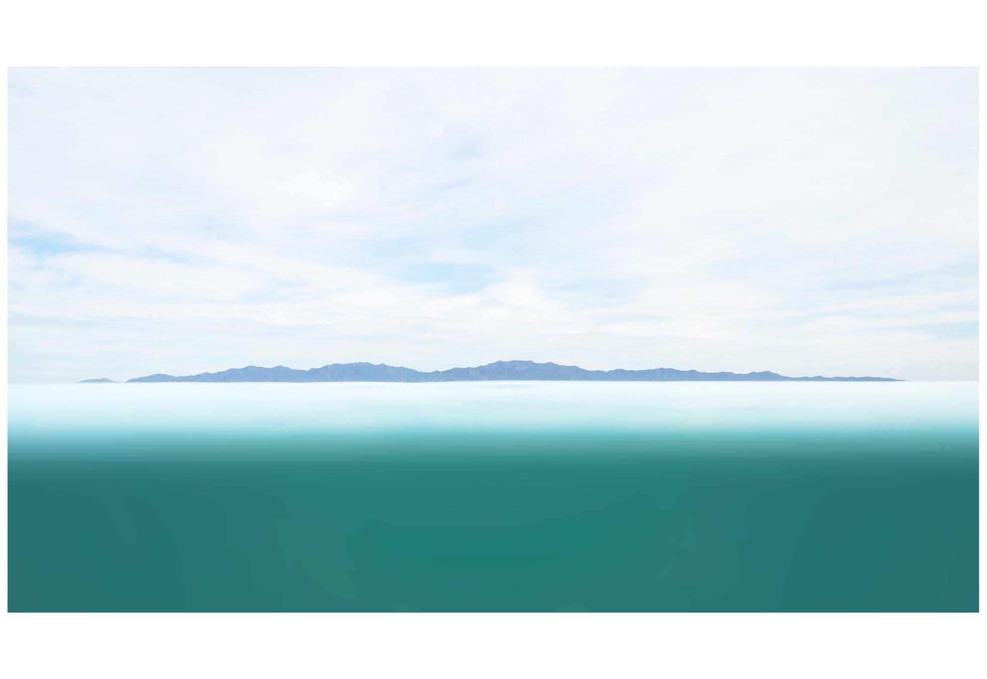 Mer turquoise et horizon de montagnes